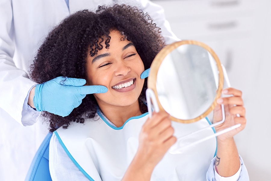 Patient smiling while having a dental exam