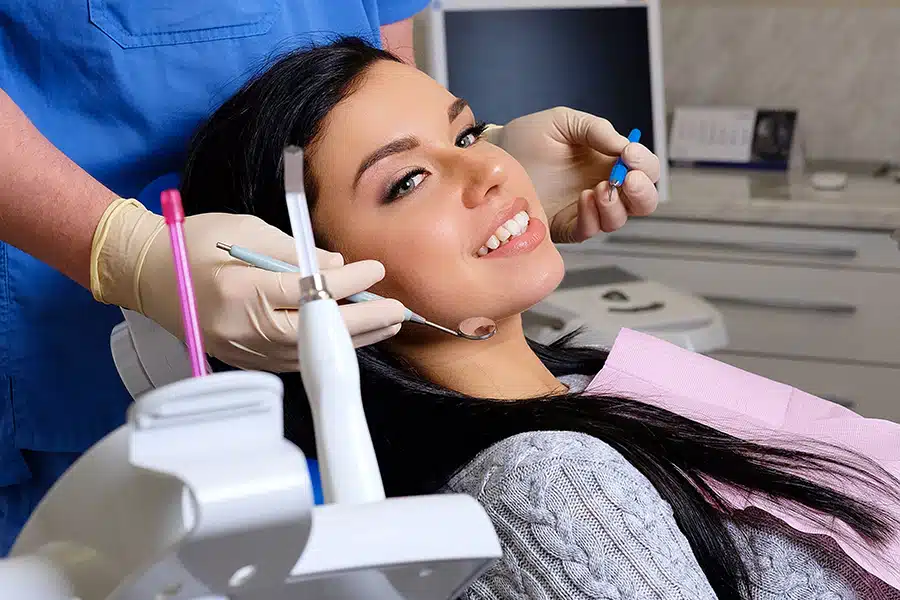 Patient smiling while having a dental exam