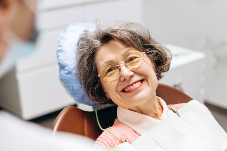Patient smiling while having a dental exam