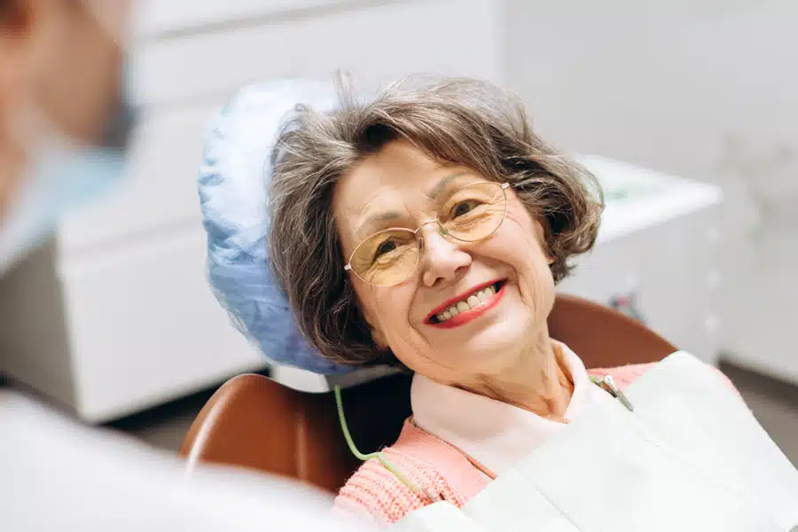 Patient smiling while having a dental exam