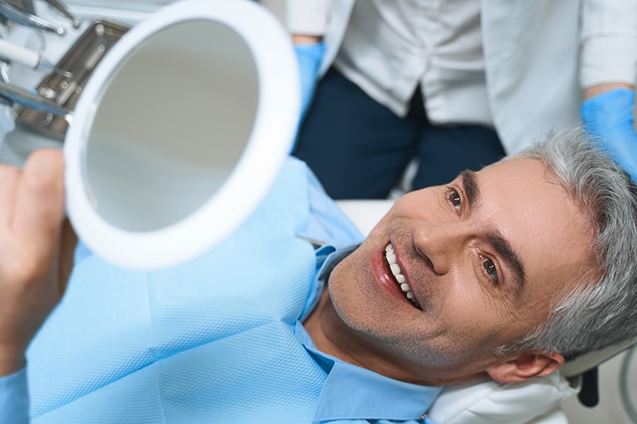 Patient smiling while having a dental exam